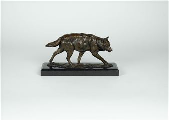 A bronze sculpture of a wolf in mid-stride on a dark rectangular base.
