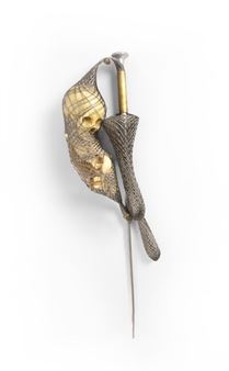 A brooch featuring a golden skull entwined with a dark, textured snake-like form.