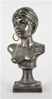 A metallic bust of a figure with a wrapped head and large hoop earring, mounted on a square base.