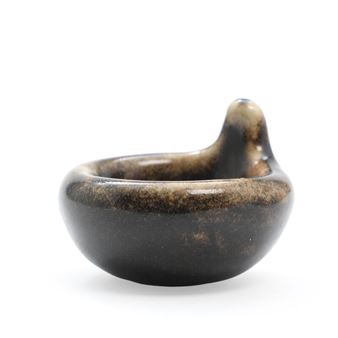 A small, dark ceramic bowl with a unique bird-like protrusion on its rim.