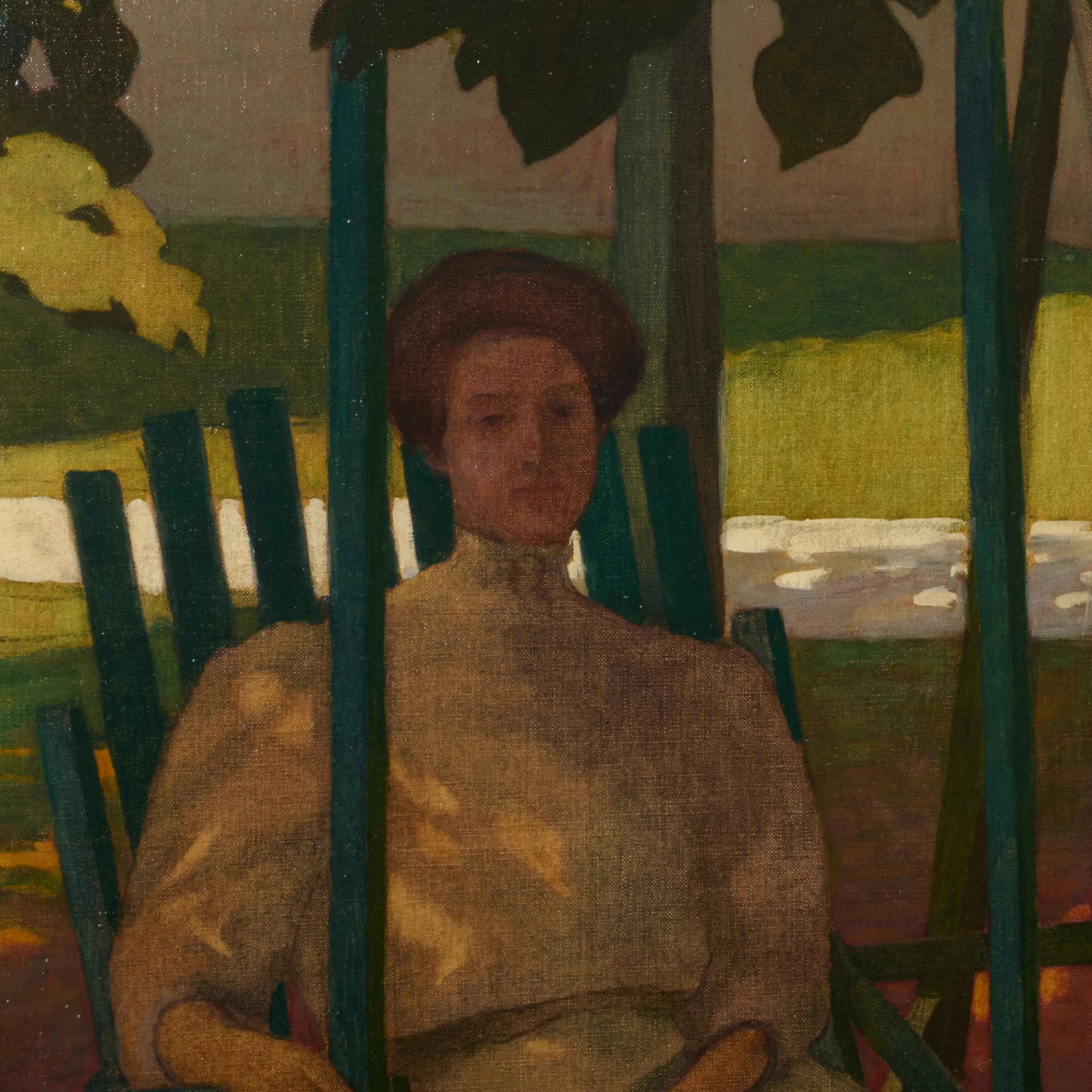 A figure in a long dress sits on a green chair under a pergola, surrounded by autumn leaves.