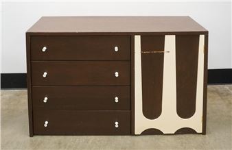 A mid-century modern chest of drawers featuring a bold geometric design.
