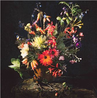 A vibrant still life of wildflowers arranged in a rustic wooden vase.