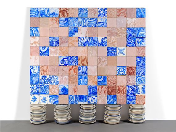 A grid of blue and terracotta tiles supported by stacks of plates.