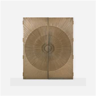 A golden cabinet with a sunburst design on its doors.