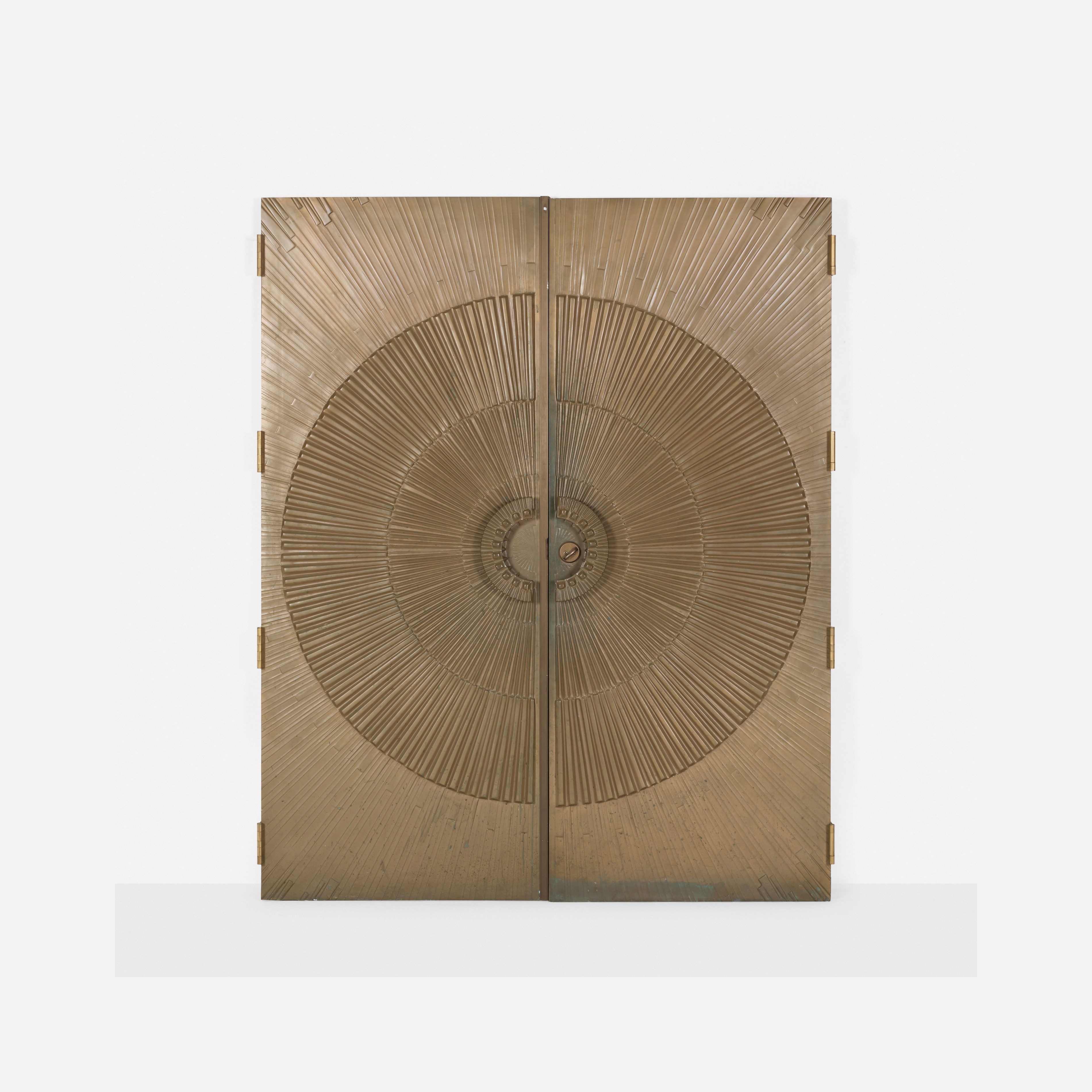 A golden cabinet with a sunburst design on its doors.
