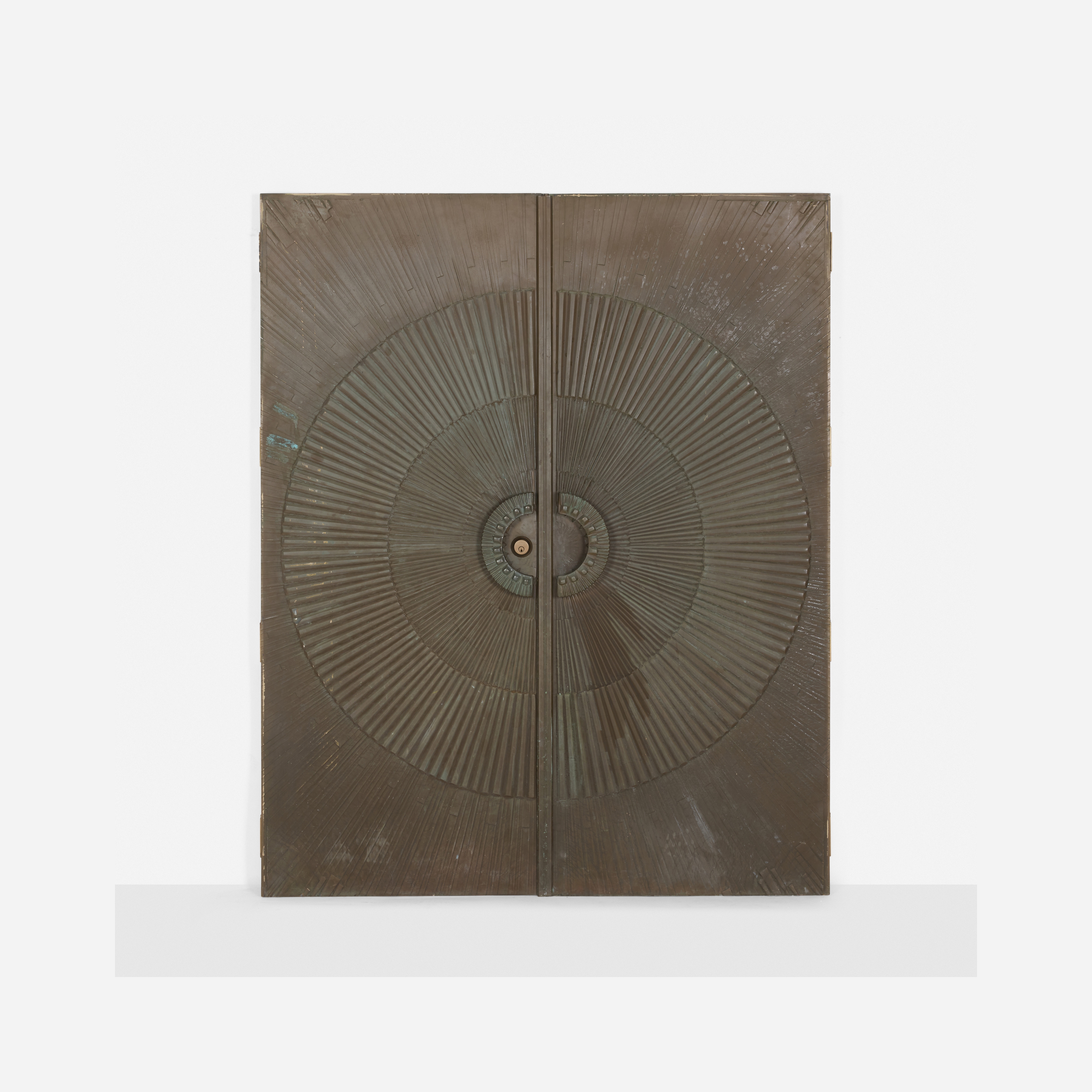A golden cabinet with a sunburst design on its doors.