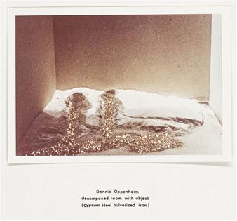 A monochromatic photograph of a textured, fragmented object resting on a flat surface within a corner.