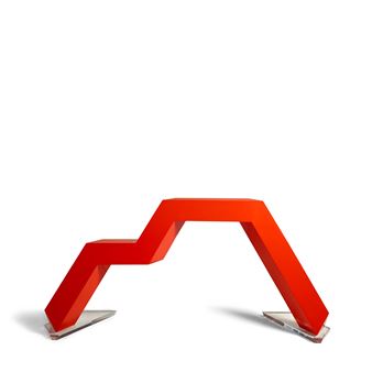 A bold red zigzag sculpture resting on metallic bases against a stark white background.