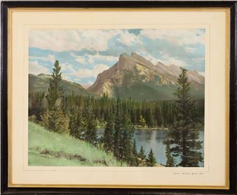 A framed landscape print featuring a majestic mountain range, a calm lake, and a dense forest under a cloudy sky.