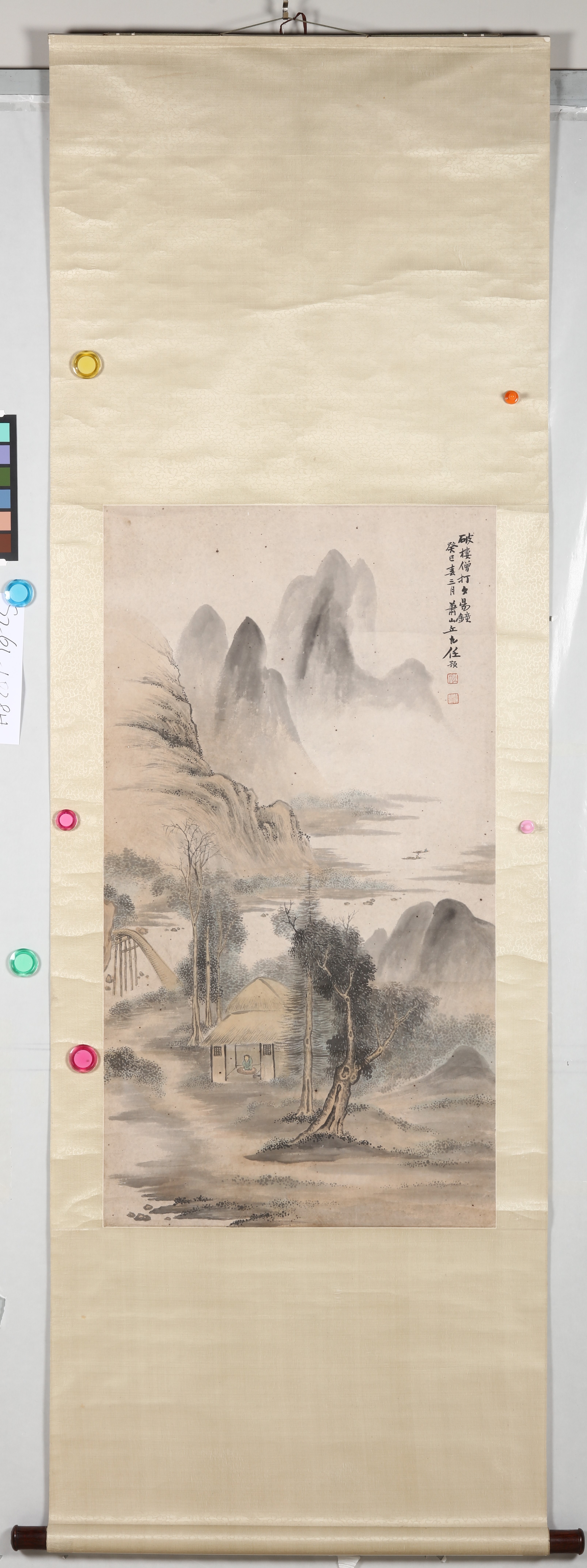 A traditional ink landscape painting depicting a misty mountain village with a bridge and small hut.