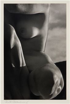 A black-and-white close-up of a human torso and hand, emphasizing soft curves and dramatic lighting.