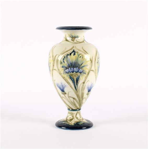 A hand-painted ceramic vase featuring a floral design against a pale background.