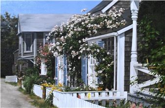 A charming street scene featuring a white picket fence and a house overflowing with blooming roses.