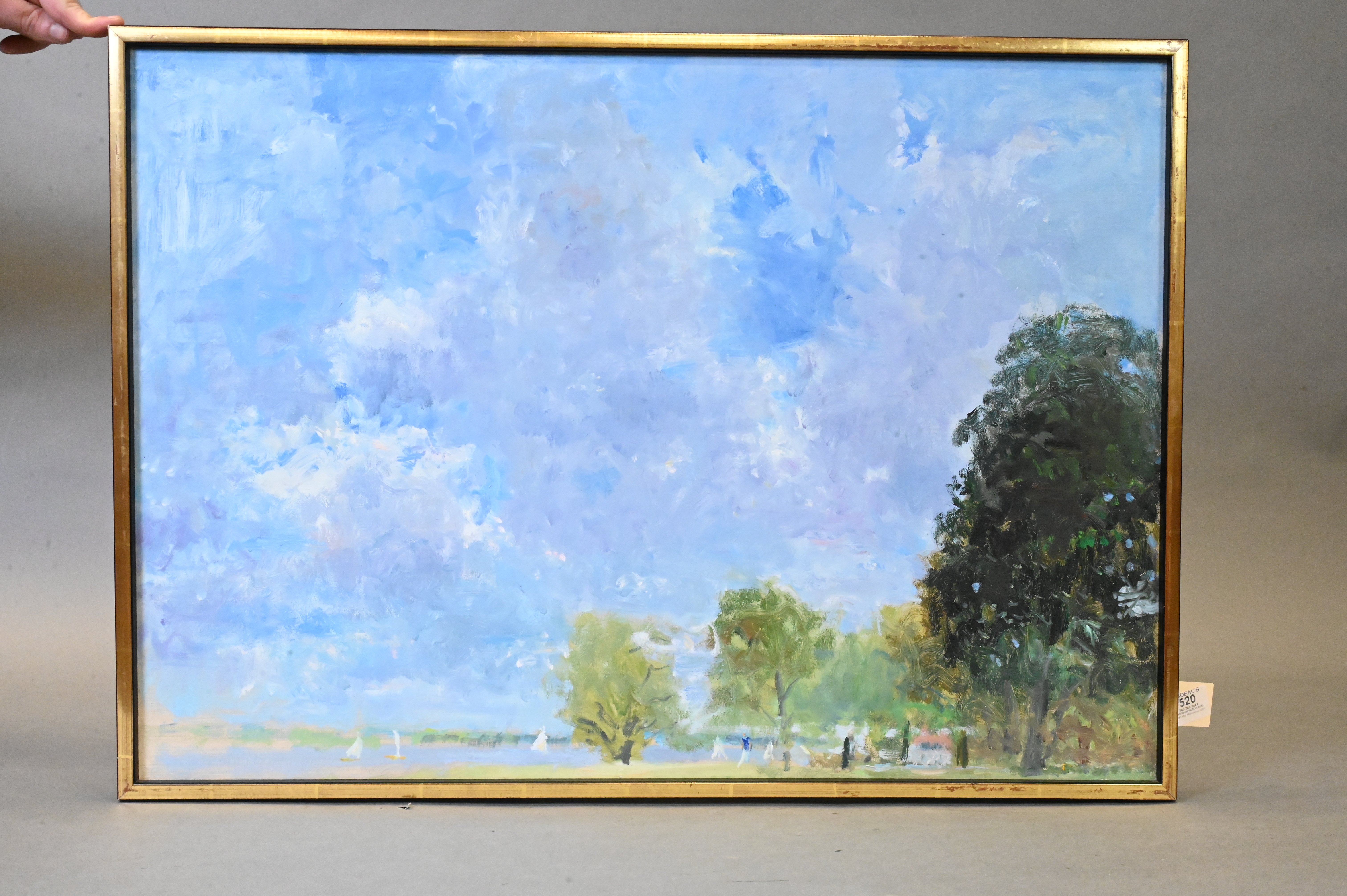 A serene landscape painting featuring a vast blue sky, distant trees, and tiny figures on a grassy shore.