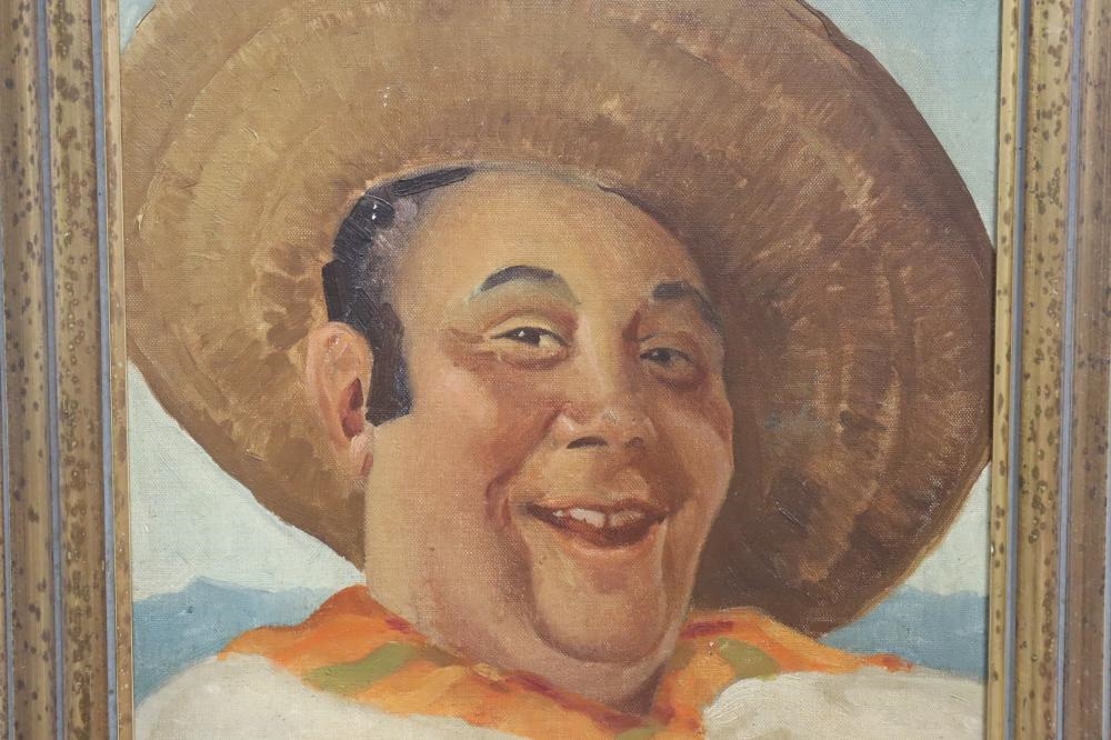 A framed portrait of a smiling man in a sombrero and white shirt against a polka-dotted background.