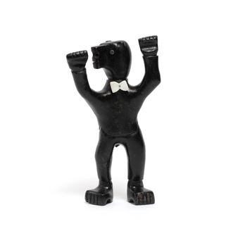 A small black figurine of a bear in a tuxedo with raised fists, set against a stark white background.