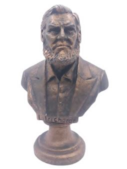 A bronze bust of a bearded man in formal attire, mounted on a pedestal base.