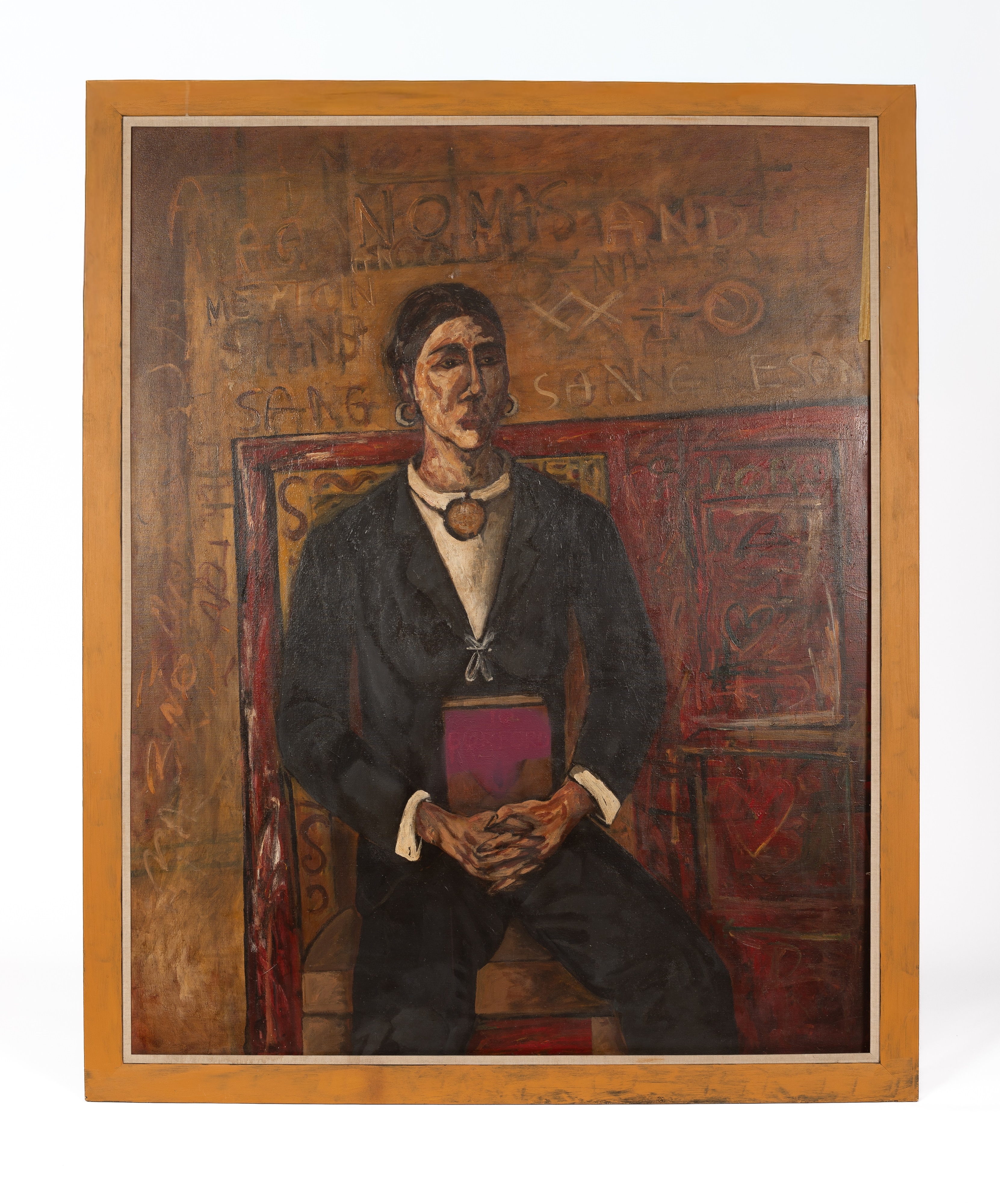 A somber portrait of a seated figure in dark clothing holding a red book, set against a textured wall covered in faint inscriptions.