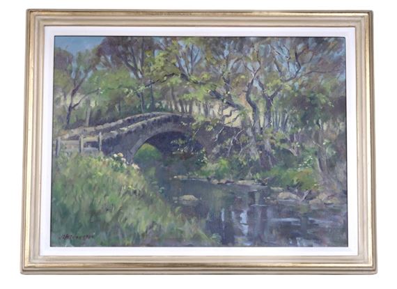 A serene landscape painting of a stone arch bridge over a river, framed in gold.