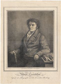 A monochromatic portrait of a seated figure in formal attire holding a rolled object.