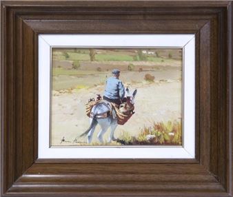 "A framed oil painting of a person riding a donkey through a rural landscape."