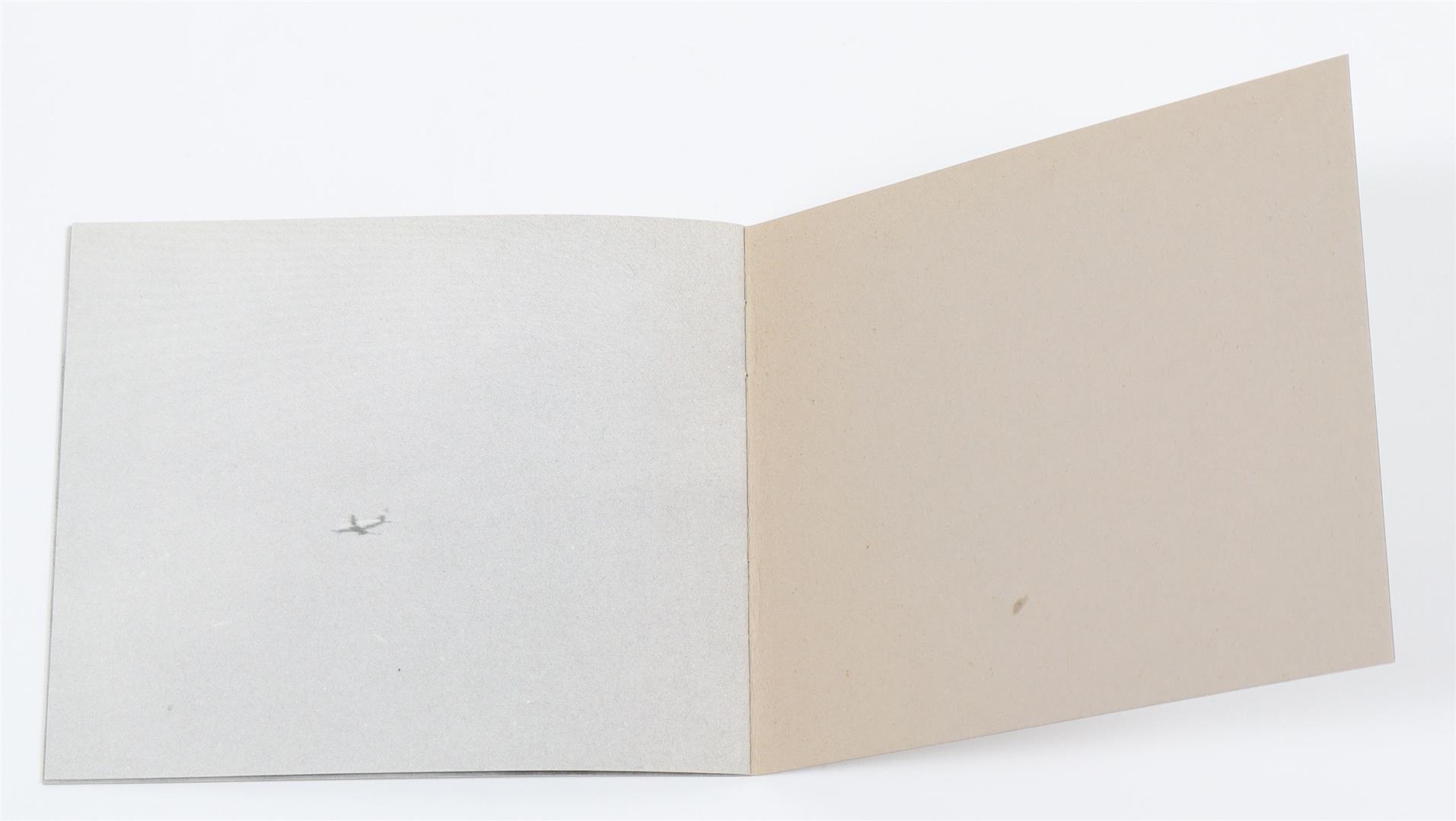 A minimalist arrangement of rectangular cards in varying shades of beige and gray, each printed with numbers and text.