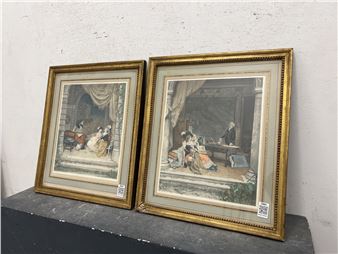 A pair of framed classical paintings depicting figures in an interior setting, resting on a dark surface against a plain wall.