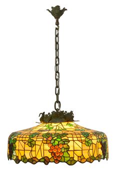 A stained glass pendant lamp featuring a grapevine motif and warm amber tones.