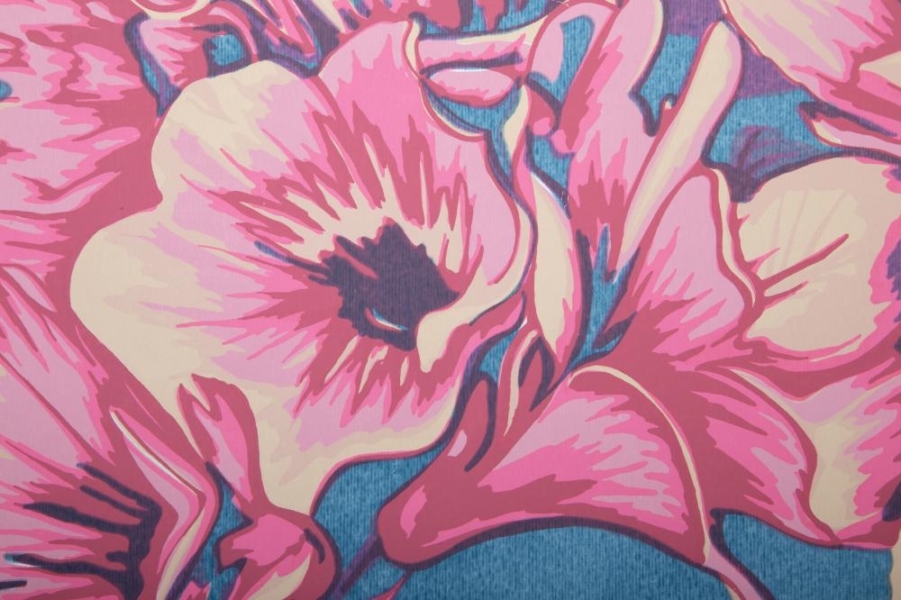A circular floral print featuring pink blossoms against a teal background.