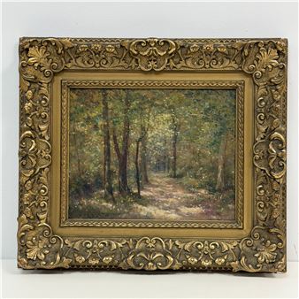 A forest path scene in an ornate gold frame.