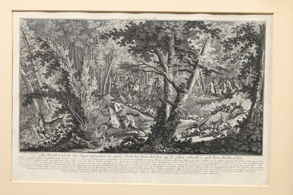 A set of four framed black-and-white etchings depicting forest scenes with figures.