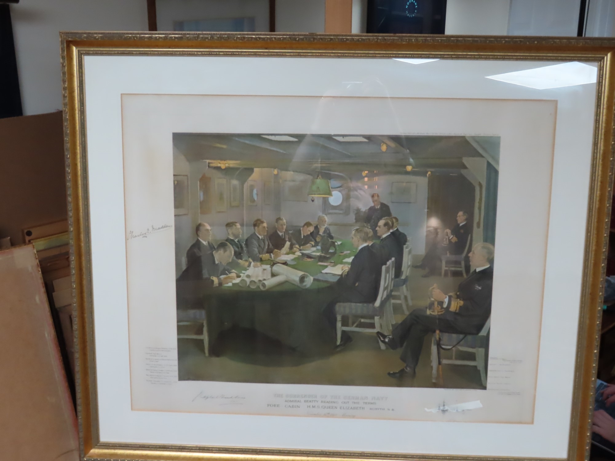 A formal meeting scene with naval officers gathered around a large table in a dimly lit room.