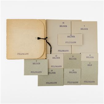 A collection of beige paper envelopes and cards arranged on a white background.