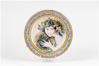 A decorative plate featuring a portrait of a woman with floral hair against a patterned rim.