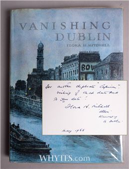 A vintage book cover featuring a watercolor cityscape with a handwritten note overlay.