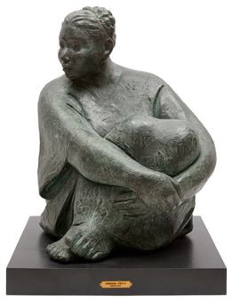 A bronze sculpture of a seated figure holding a large, rounded object.