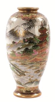 A decorative ceramic vase featuring a detailed landscape scene with Mount Fuji and a pagoda.