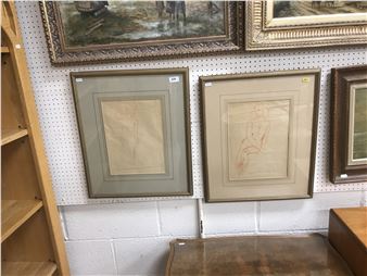 A collection of framed sketches and paintings displayed on a pegboard wall.