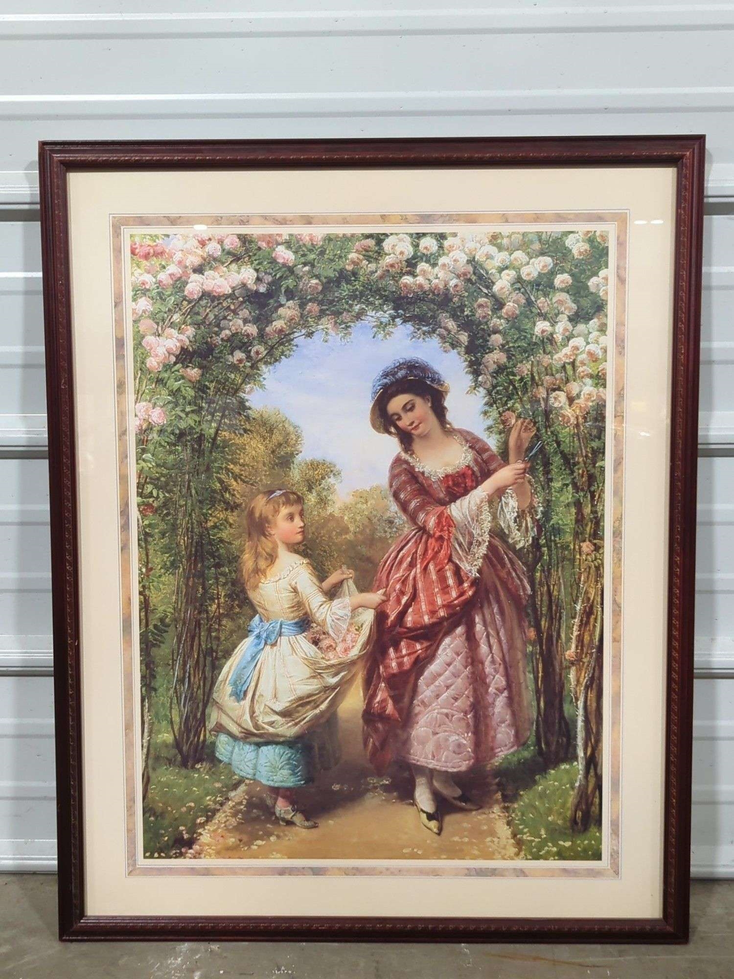 Two framed paintings depicting women in historical dress, one with three figures and another with two figures under a floral arch.
