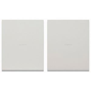 A minimalist composition of two identical square objects with subtle text.