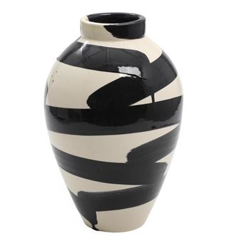 A glossy ceramic vase with bold black and white abstract brushstrokes.