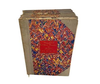 A stack of vintage books with a vibrant marbled cover and red label.
