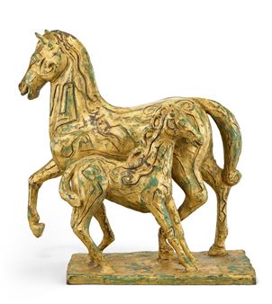 A sculptural pair of horses in gold and green glaze with intricate surface detailing.