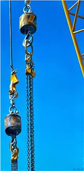 A close-up of industrial machinery against a vivid blue sky.