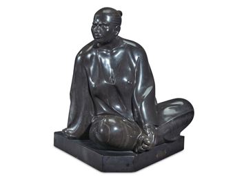 A polished bronze sculpture of a seated figure in a meditative pose.