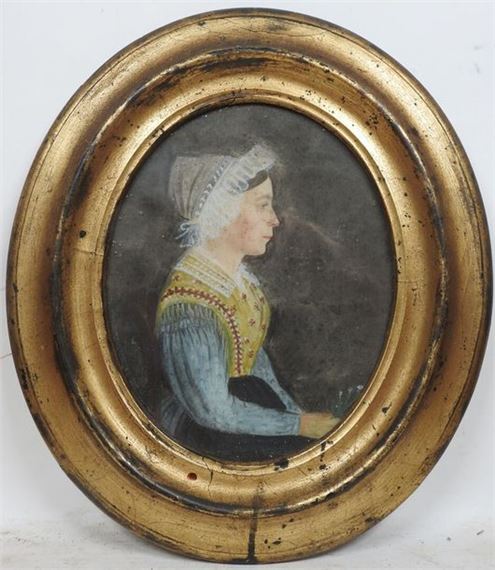 A profile portrait of a woman in a gold frame.