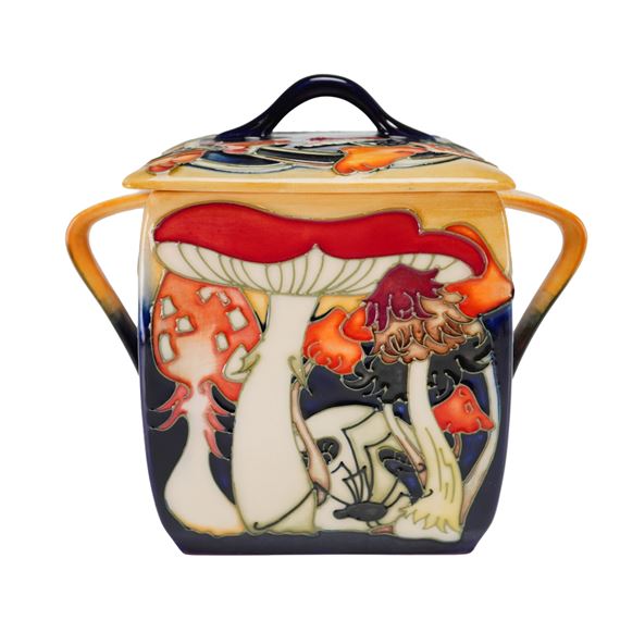A ceramic jar featuring a vibrant, stylized forest scene with mushrooms.