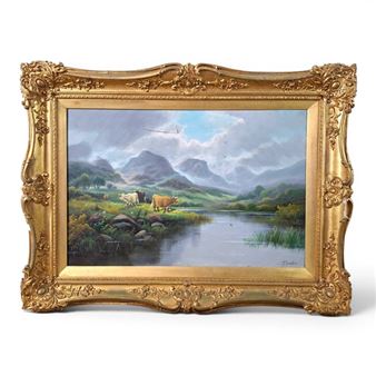 A pastoral landscape painting in an ornate gold frame featuring cows near a lake with distant mountains.