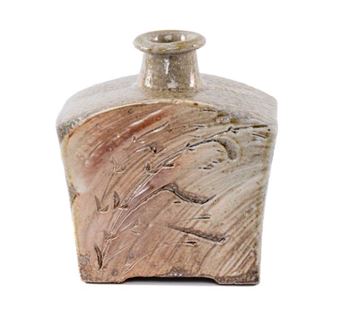 A handcrafted ceramic vessel with a narrow neck and textured surface featuring incised botanical motifs.